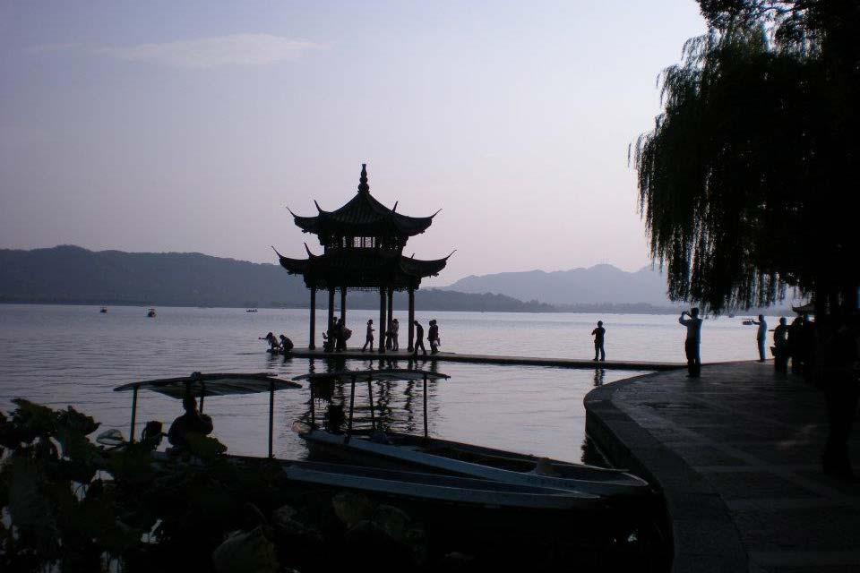 An evening photo of a lake with a gazebo