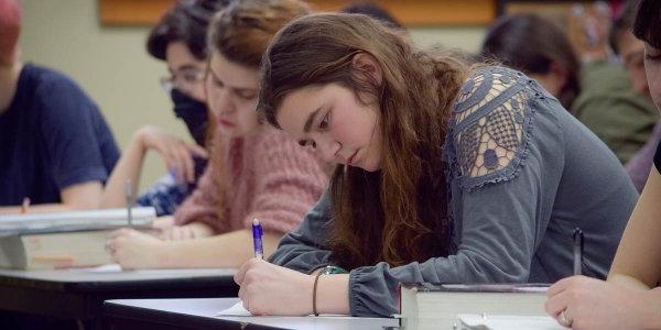 Student taking notes while in class