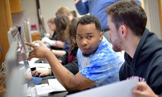 Students work on a computer in a classroom