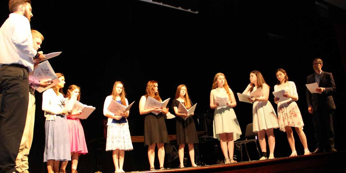 Students singing on stage