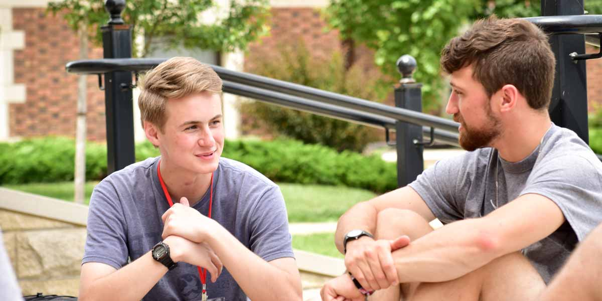 Two members of a youth group talking